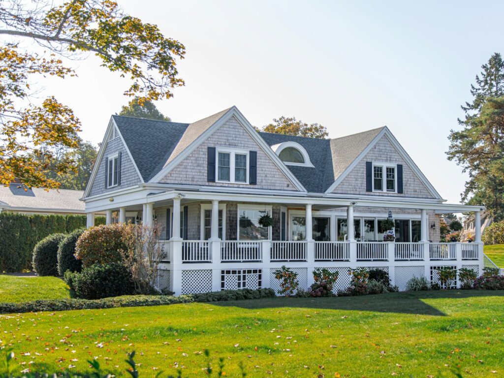 Two-story American home with a wraparound porch